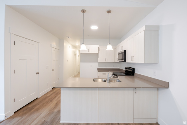4664 South 680th West, Unit S304 Mapleton, UT 84664 - Photo 14 of 16 Kitchen featuring light-toned cabinetry, light gray countertops, and modern pendant lighting