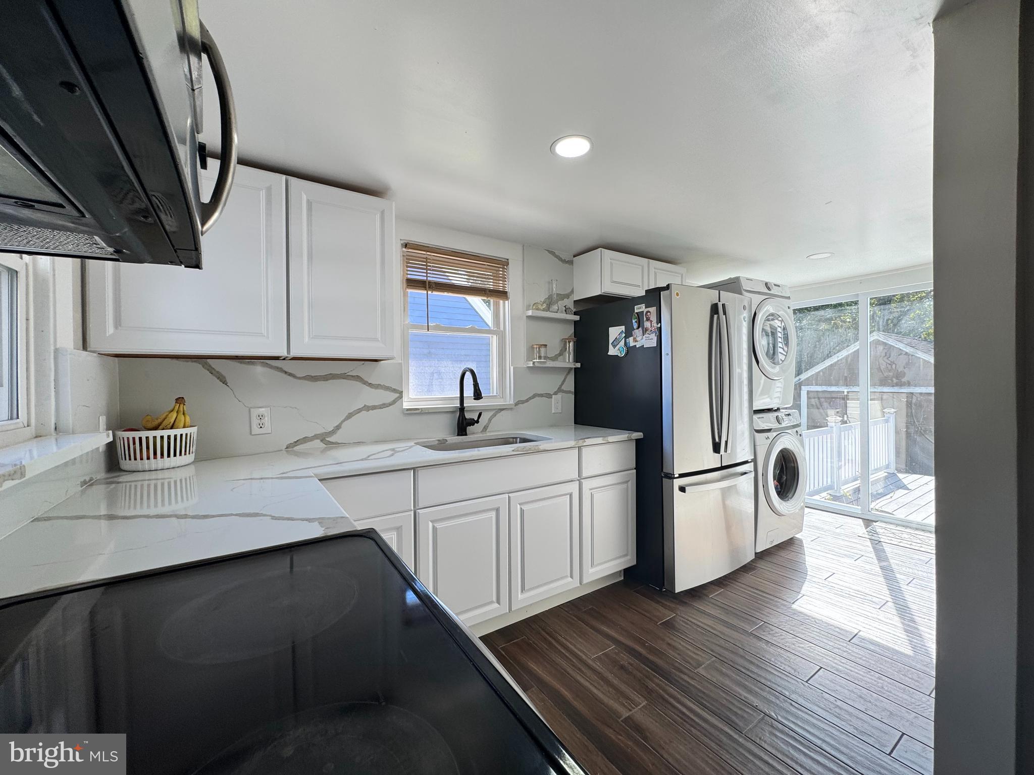 1012 Phillips Avenue Salisbury, MD 21804 - Photo 12 of 33 a kitchen with white cabinets and wooden floor
