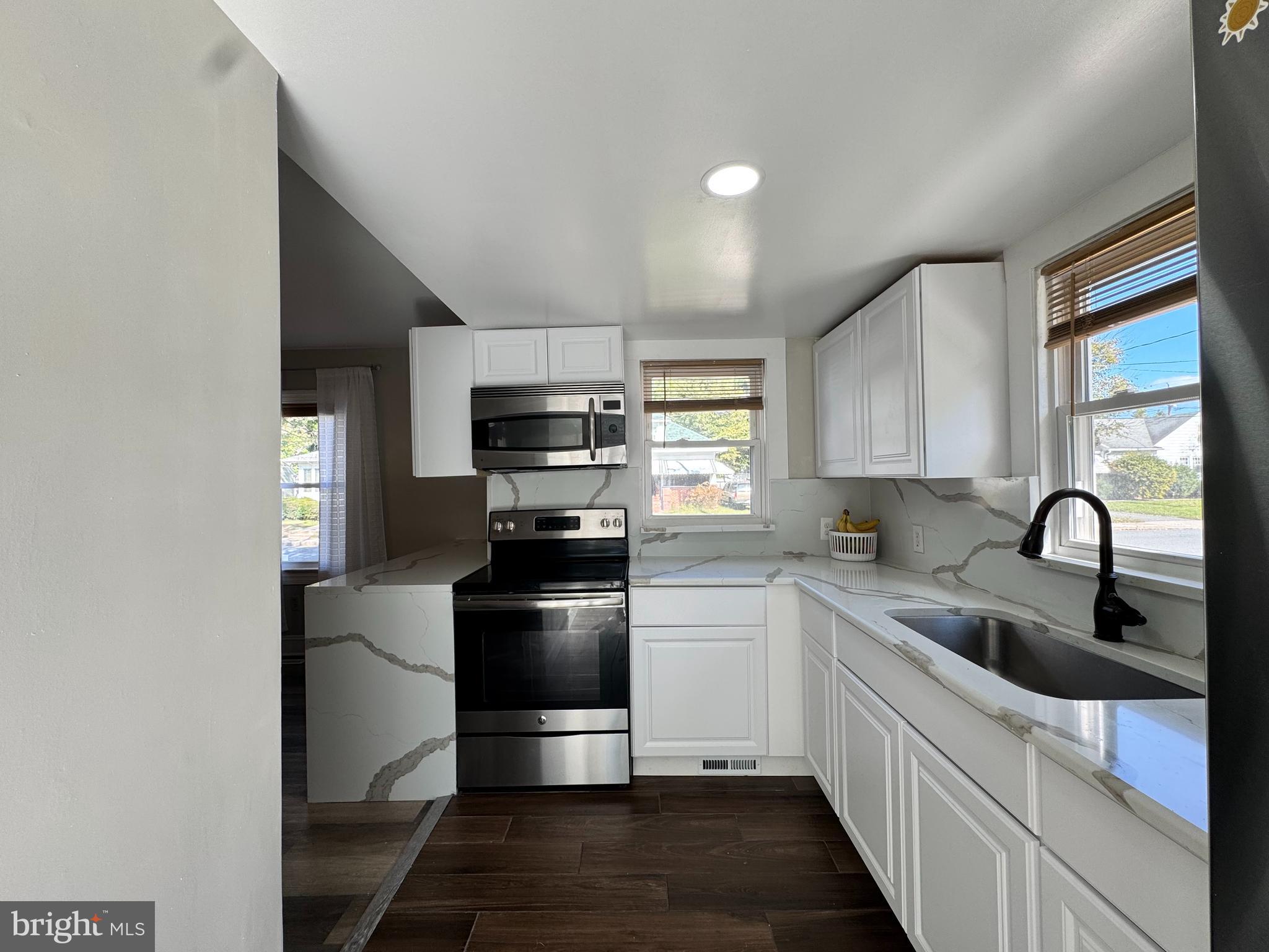 1012 Phillips Avenue Salisbury, MD 21804 - Photo 14 of 33 a kitchen with a refrigerator sink and white cabinets