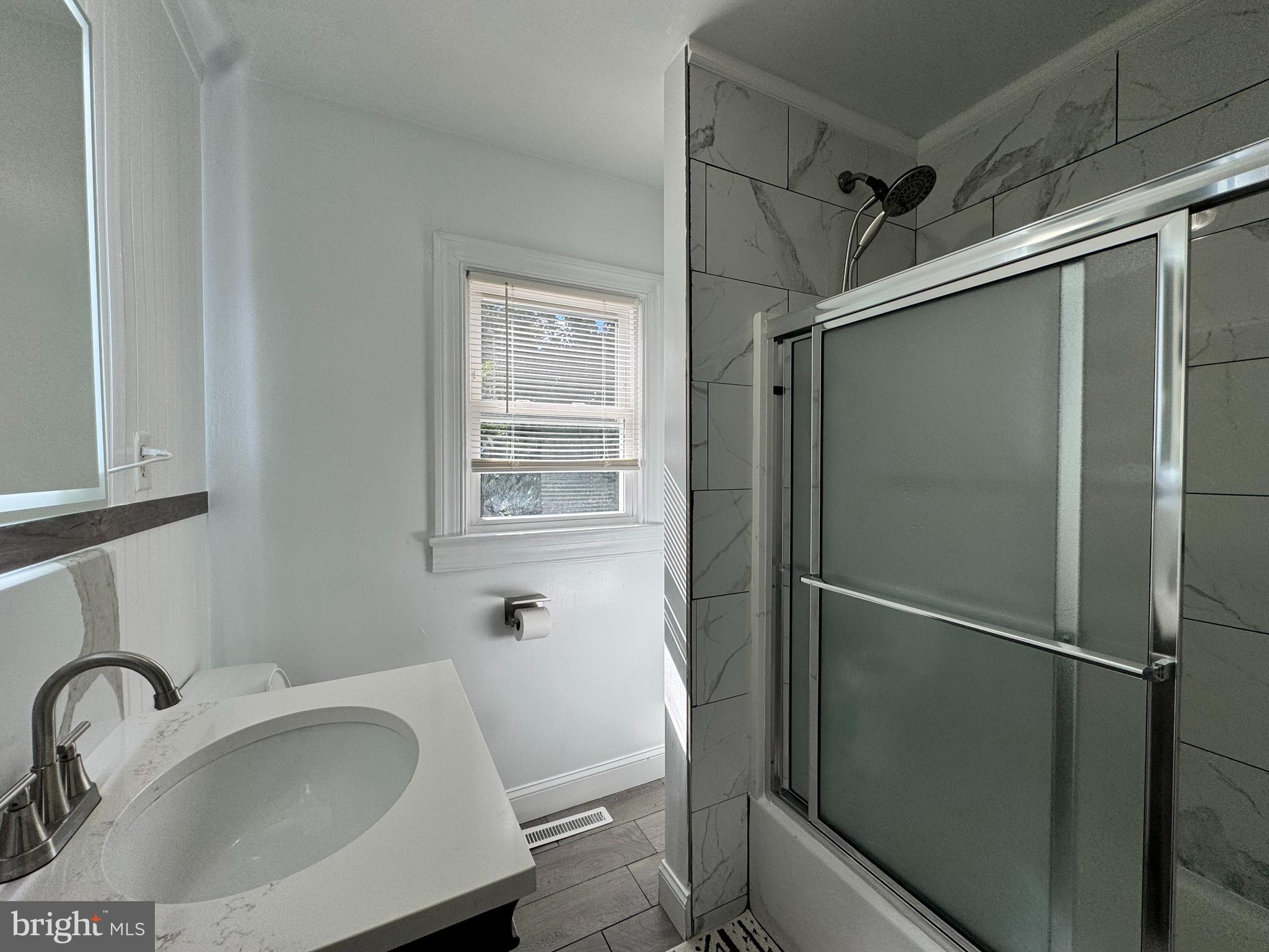 1012 Phillips Avenue Salisbury, MD 21804 - Photo 22 of 33 a bathroom with a sink and mirror
