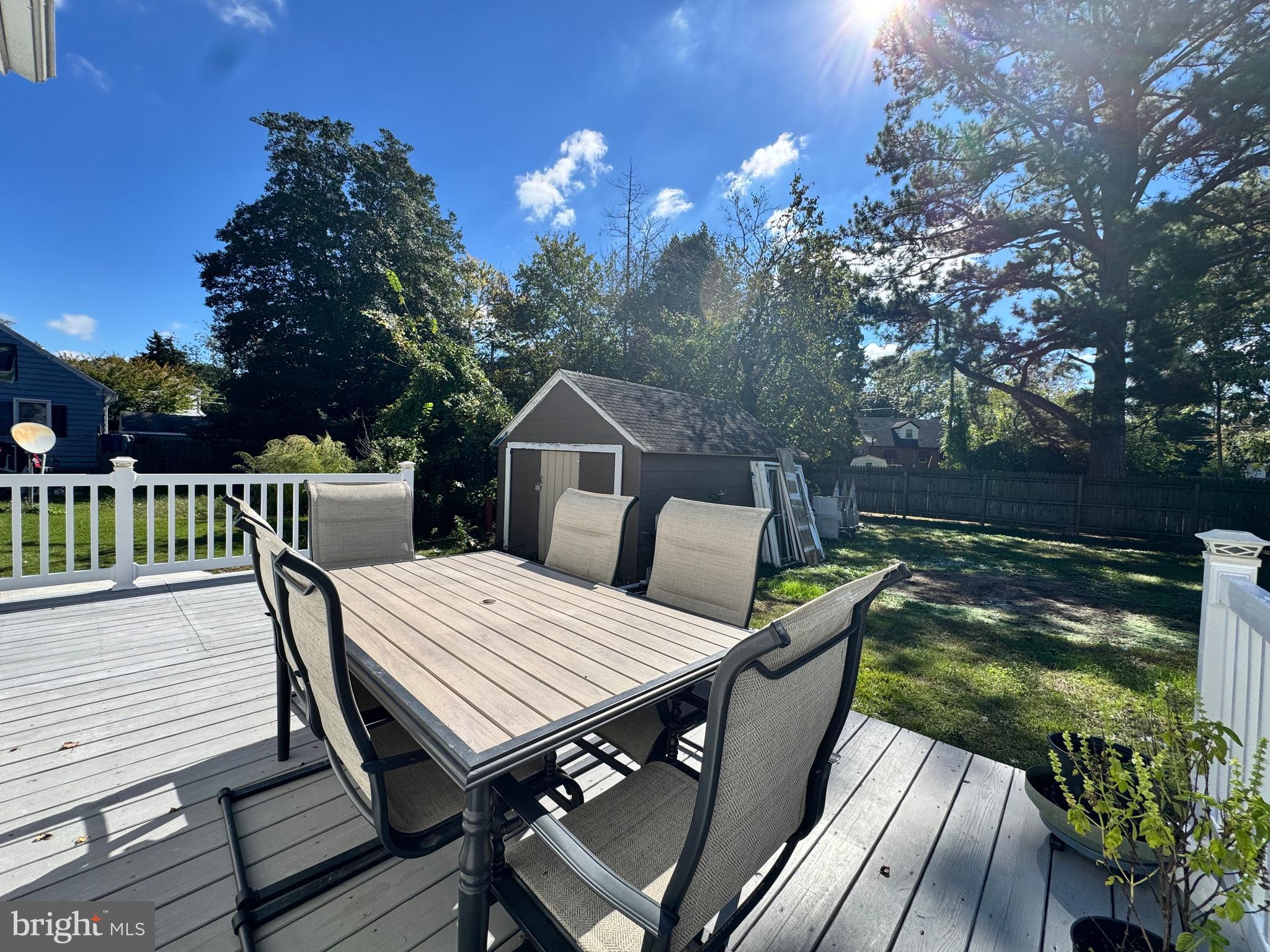 1012 Phillips Avenue Salisbury, MD 21804 - Photo 32 of 33 a view of a roof deck with table and chairs with wooden floor and fence