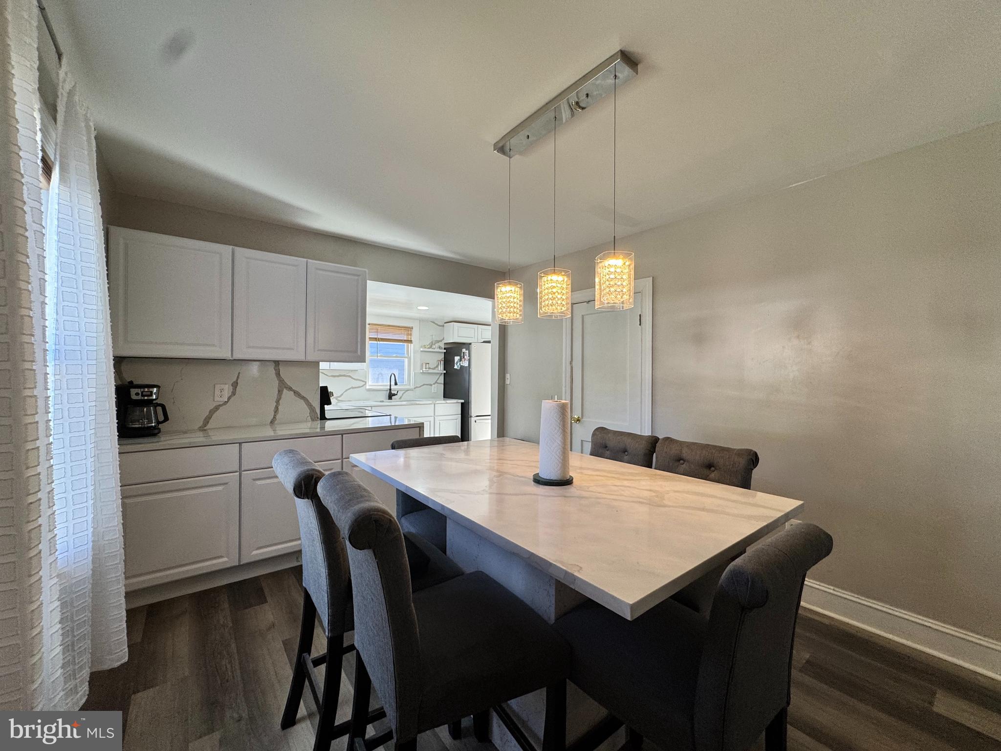 1012 Phillips Avenue Salisbury, MD 21804 - Photo 7 of 33 a kitchen with a table chairs and white cabinets
