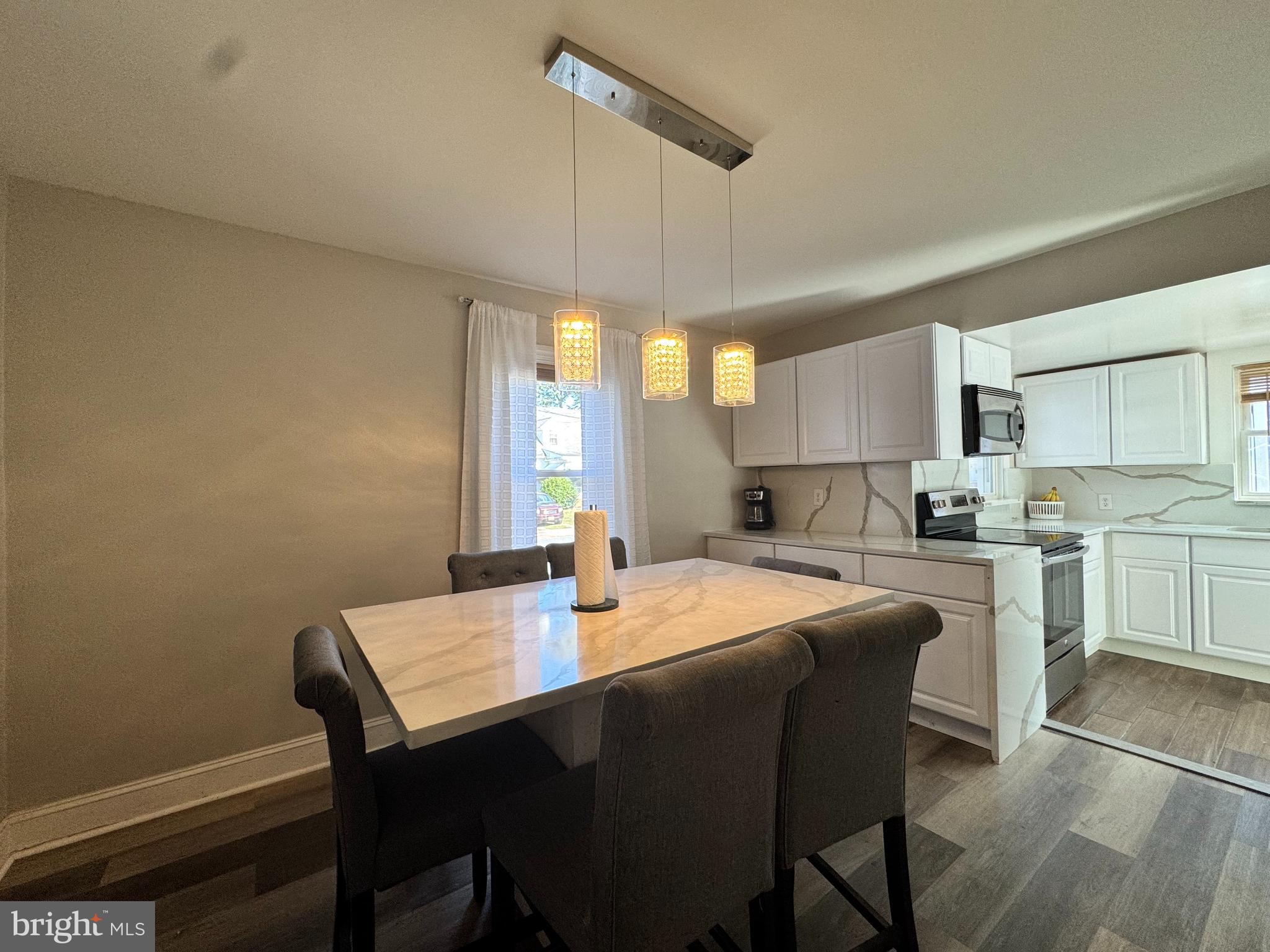 1012 Phillips Avenue Salisbury, MD 21804 - Photo 8 of 33 a kitchen with a dining table chairs and white cabinets