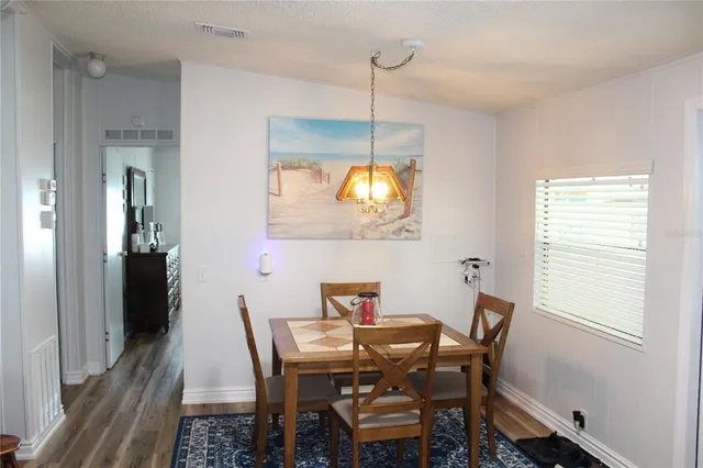 a view of a dining room with a table and chairs
