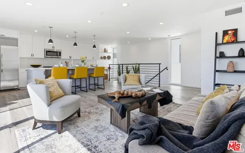 a living room with furniture and kitchen view