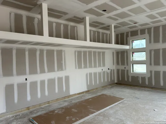 a large kitchen with a large island in the center and a large window