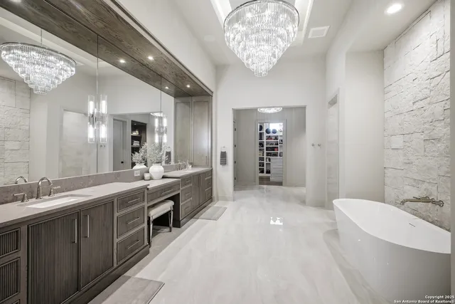 a spacious bathroom with a double vanity sink a toilet and a shower