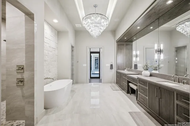 a large white kitchen with a large window and stainless steel appliances