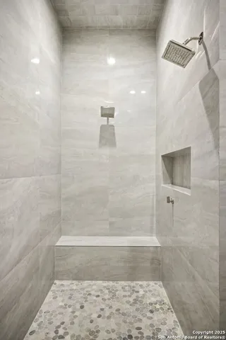 a hallway with mirror and window