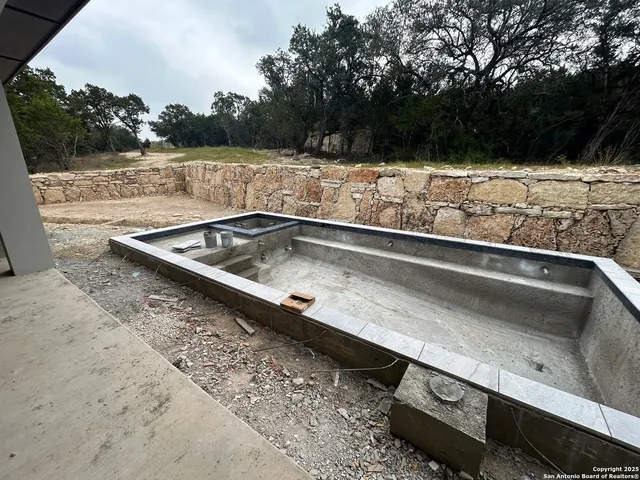 a view of a swimming pool with a yard