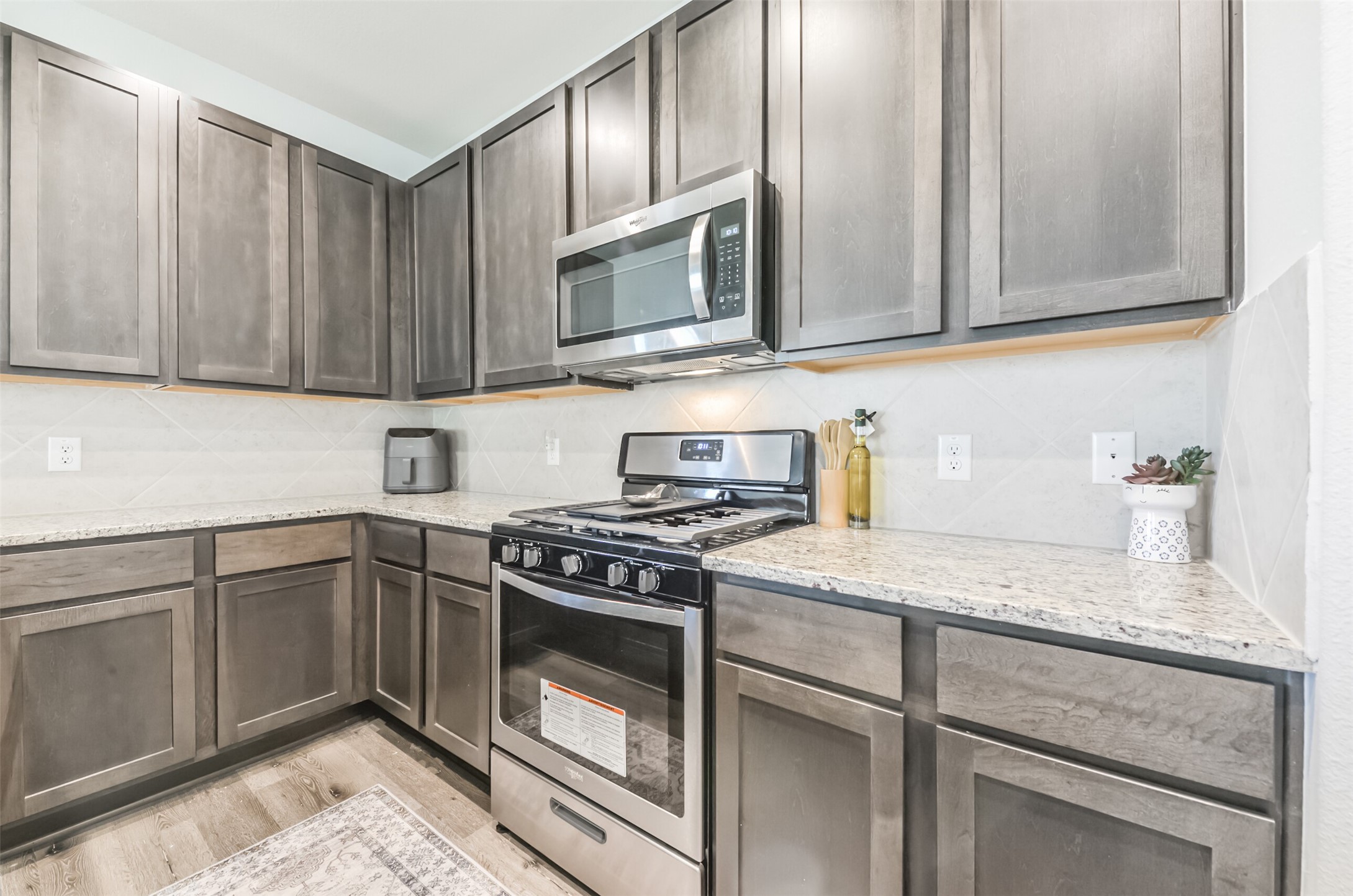 5522 Briana Dee Drive Rosharon, TX 77583 - Photo 14 of 37 a kitchen with granite countertop cabinets stainless steel appliances and wooden cabinets