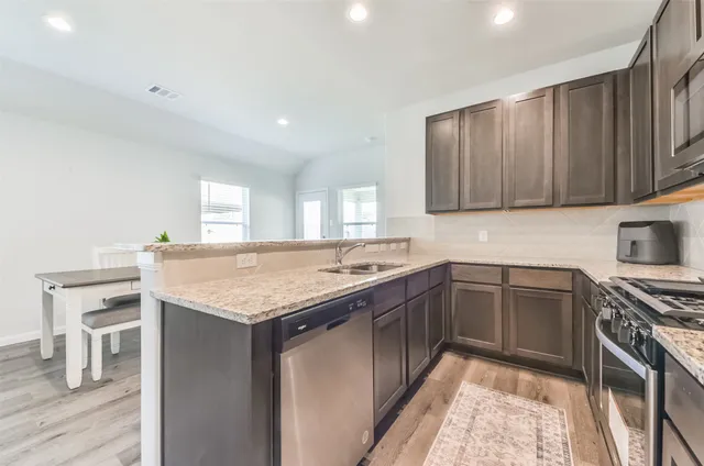 a kitchen with a sink and cabinets
