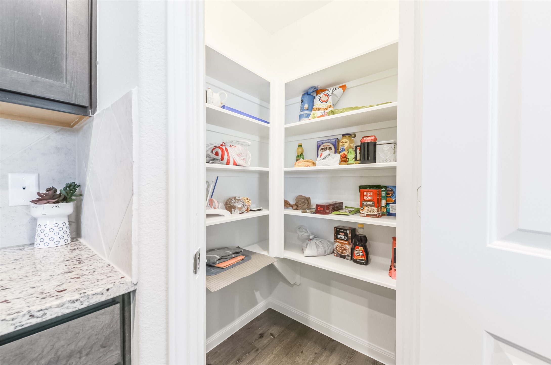 5522 Briana Dee Drive Rosharon, TX 77583 - Photo 21 of 37 a view of kitchen cabinets with food items with white countertops
