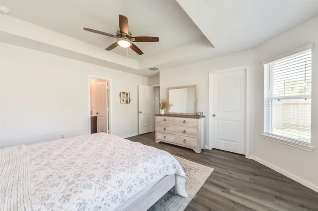 a bedroom with a bed and a dresser