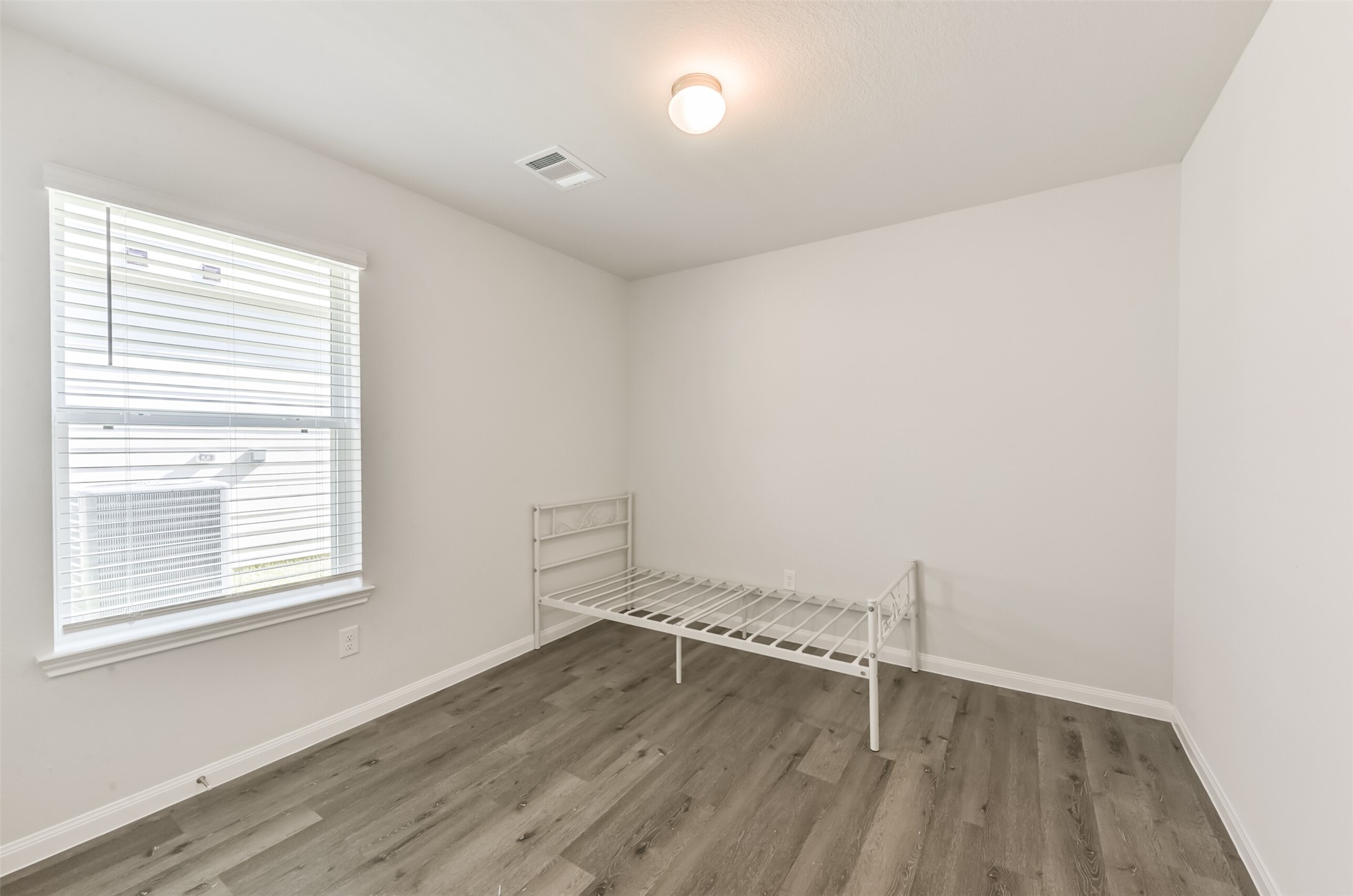 5522 Briana Dee Drive Rosharon, TX 77583 - Photo 32 of 37 an empty room with wooden floor and windows