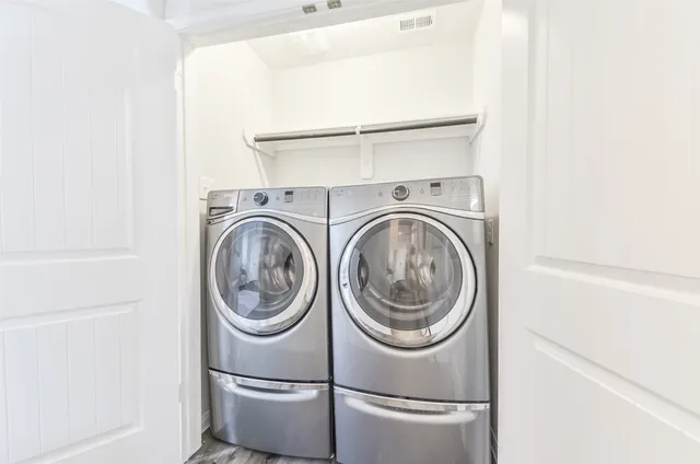 a view of a chair and table in backyard of the house