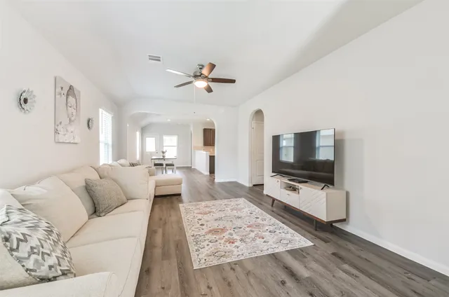a living room with furniture and a flat screen tv
