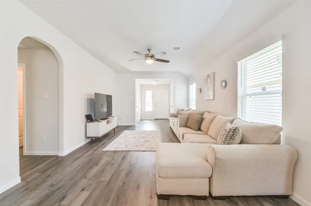 a living room with furniture and a flat screen tv