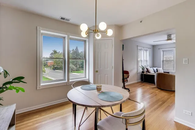 a view of a dining room with furniture window and wooden floor