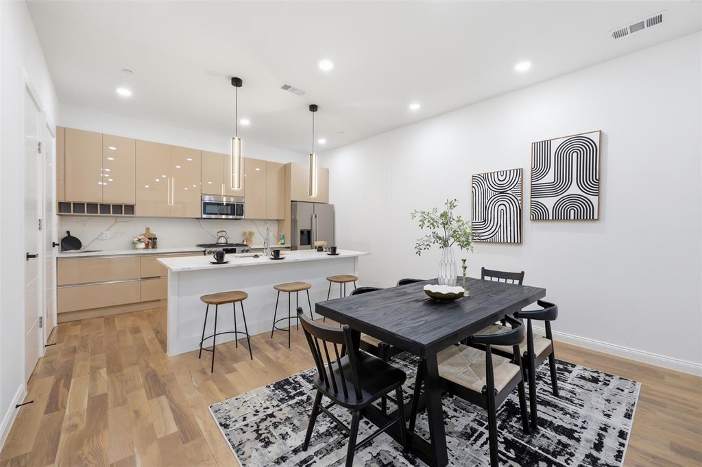1920 Caddo Street, Unit 204 Dallas, TX 75204 - Photo 12 of 33 a kitchen with a table and chairs in it