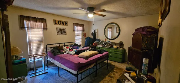 a bedroom with a bed and a tv