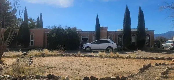 a couple of cars parked in front of a house
