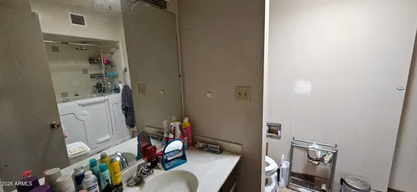 a bathroom with a toilet and a mirror