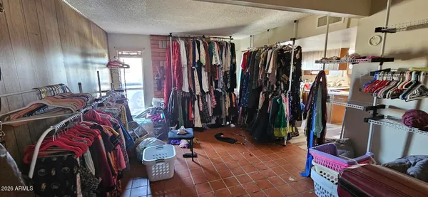 a view of walk in closet with clothes