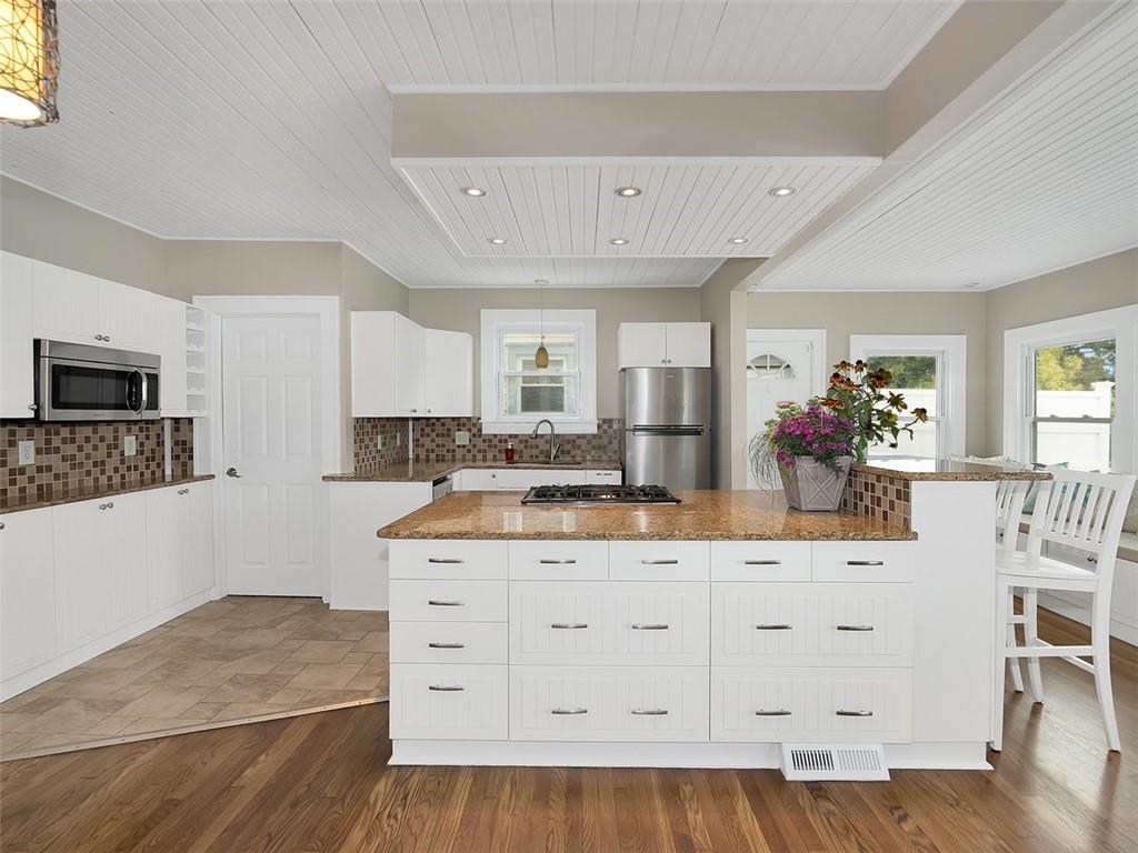 919 Atlantic Avenue Monaca, PA 15061 - Photo 10 of 25 a kitchen with granite countertop white cabinets and white appliances