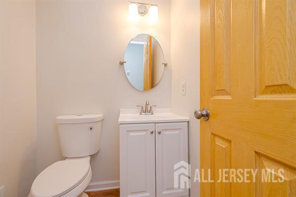 92 Reynolds Court, Unit 147 Old Bridge, NJ 07747 - Photo 11 of 19 a bathroom with a toilet sink and mirror