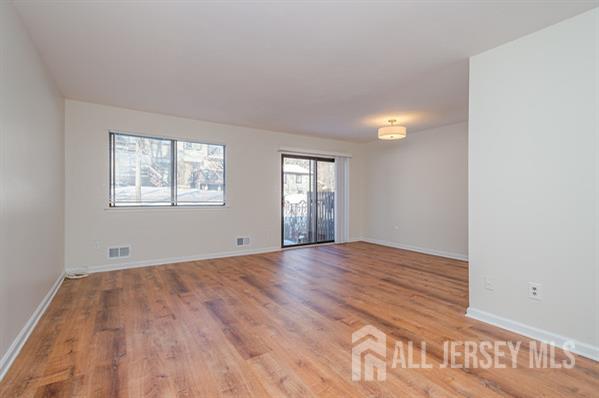 92 Reynolds Court, Unit 147 Old Bridge, NJ 07747 - Photo 6 of 19 an empty room with windows