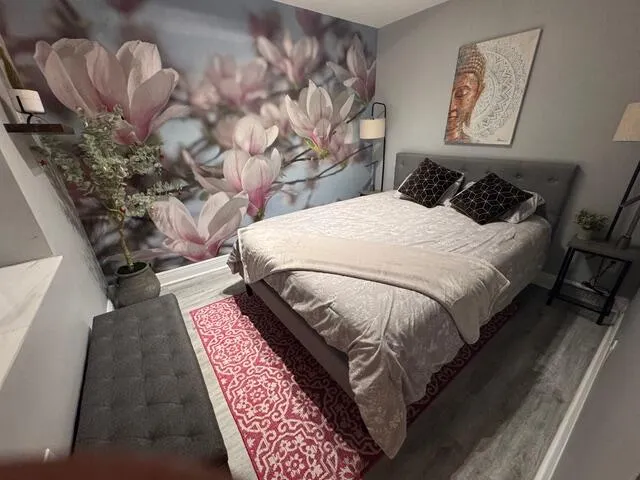 a bed sitting in a bedroom next to a lamp