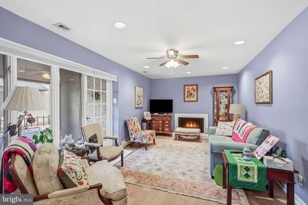 a living room with furniture fireplace and a window