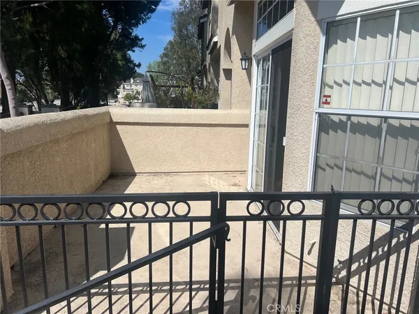 an empty room with wooden floor and fireplace