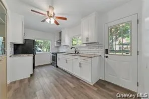 a kitchen with sink cabinets and window