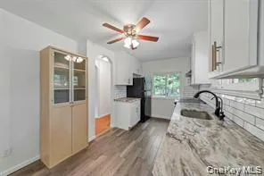 a kitchen with a refrigerator and a sink