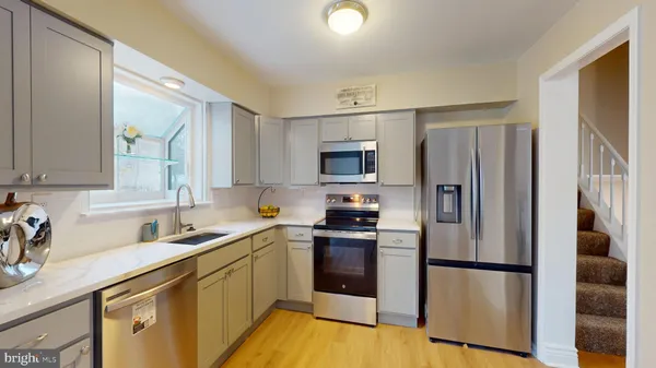 a kitchen with a refrigerator sink and microwave
