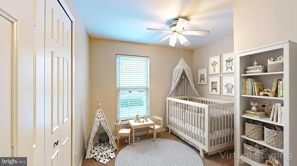 a bedroom with furniture and baby crib