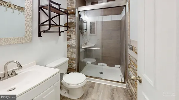 a bathroom with a sink toilet and shower