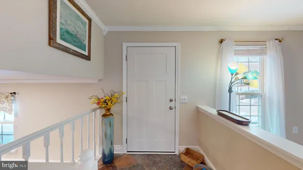 a view of hallway with paintings on the wall