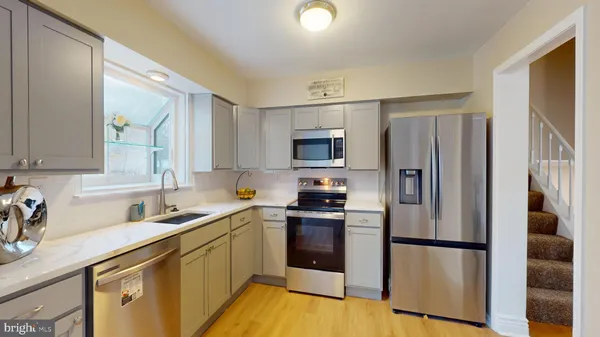 a kitchen with a refrigerator sink and microwave