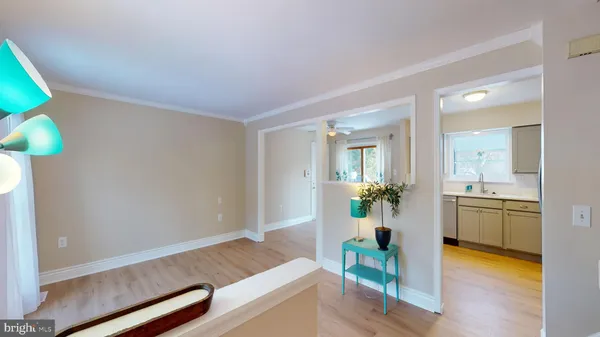a living room with furniture and a kitchen
