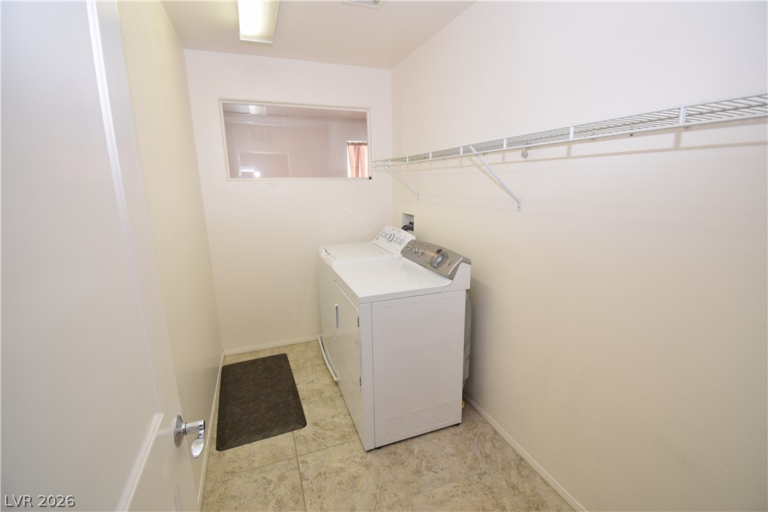 3622 Via Terracina Henderson, NV 89052 - Photo 21 of 22 Functional laundry space featuring durable tile flooring and convenient overhead shelving.