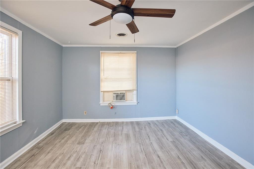 3323 Midway Road, Unit 1 Decatur, GA 30032 - Photo 8 of 10 a view of empty room with wooden floor and fan