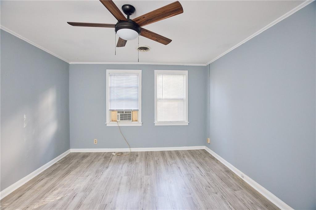 3323 Midway Road, Unit 1 Decatur, GA 30032 - Photo 9 of 10 an empty room with wooden floor fan and windows
