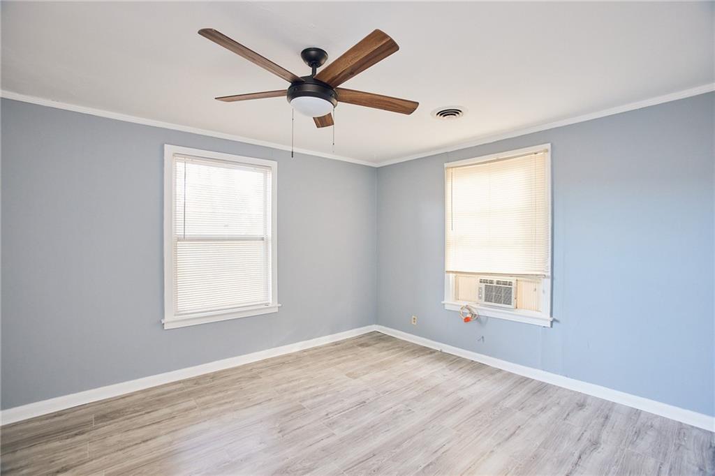 3323 Midway Road, Unit 1 Decatur, GA 30032 - Photo 10 of 10 an empty room with wooden floor windows and fan