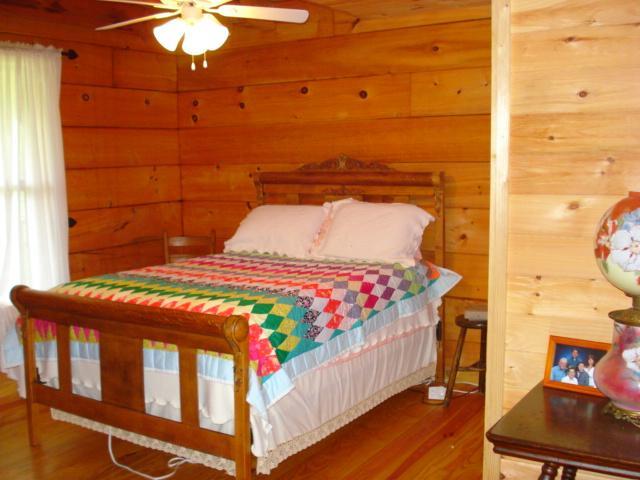 4646 Summitville Road Morrison, TN 37357 - Photo 8 of 11 a bedroom with a bed and wooden floor