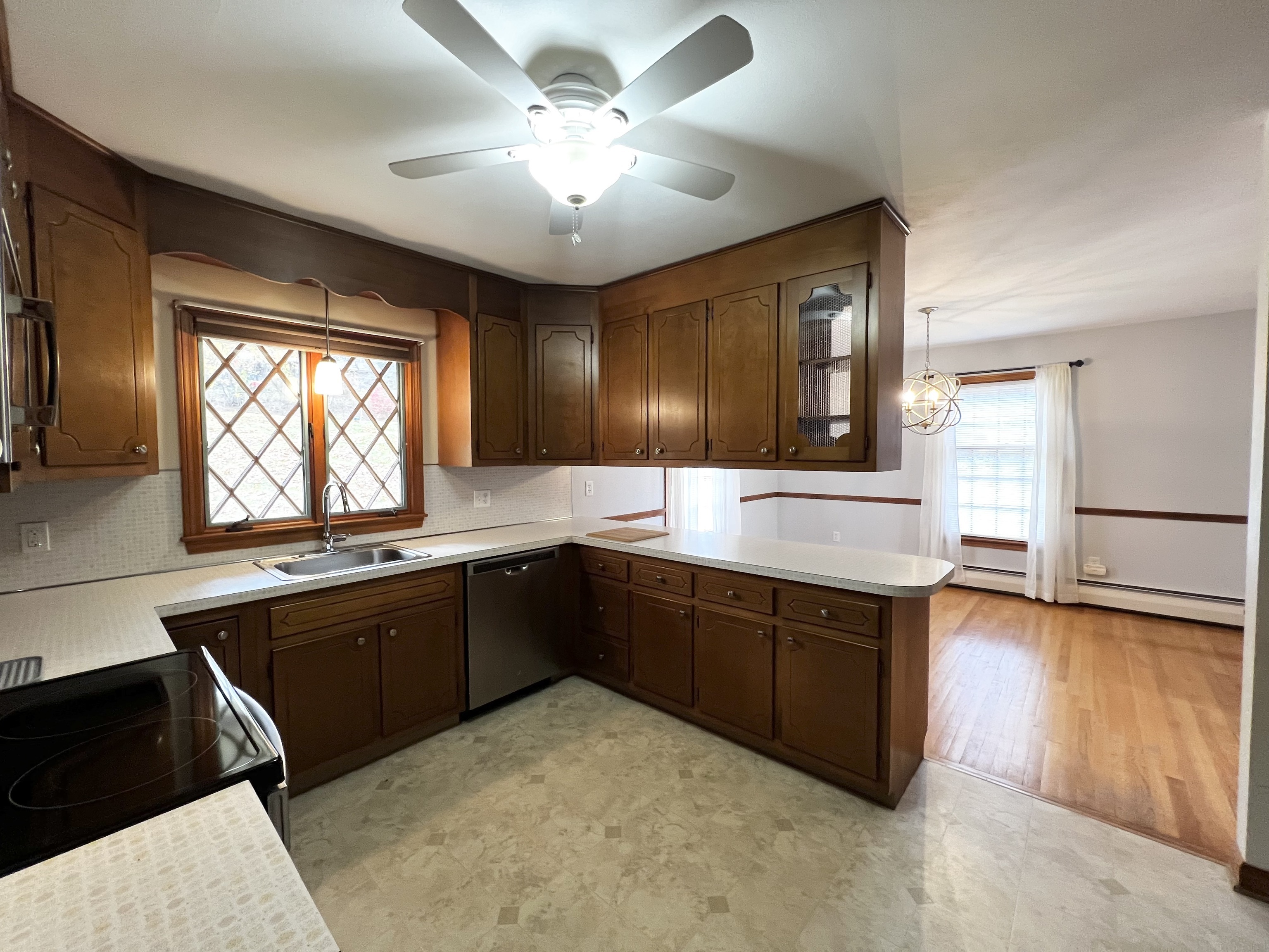 524 Saybrook Road Haddam, CT 06438 - Photo 12 of 38 a kitchen with stainless steel appliances granite countertop a sink dishwasher stove and refrigerator with wooden floor
