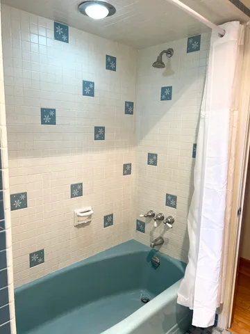 a bathroom with a granite countertop sink a shower and a mirror