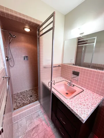 a bathroom with a sink vanity mirror and toilet